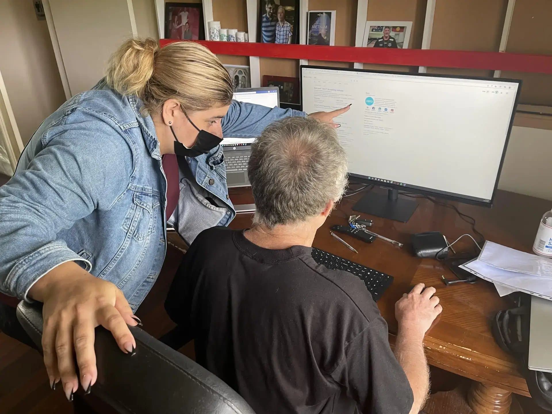 Support worker and participant reviewing an NDIS plan together at a desk